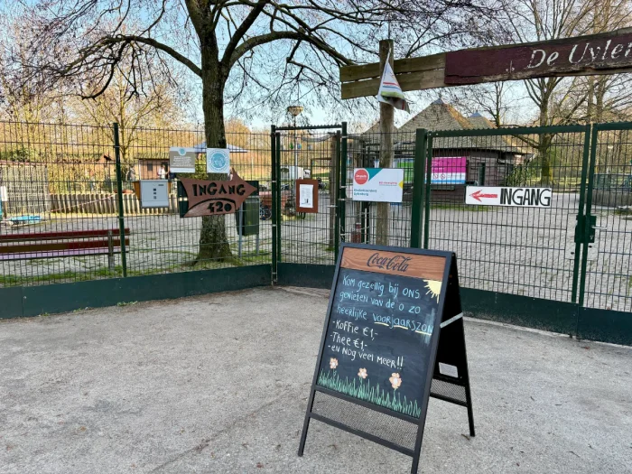Entrance gate to children's farm with sandwich sign out front advertising coffee and tea