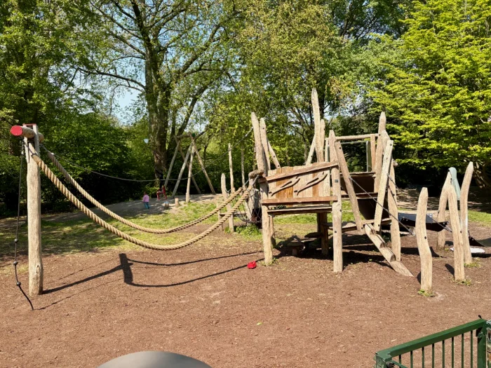 Natural wooden play structure with climbing ropes 