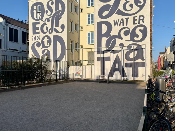 Small kids football pitch and large mural with oversized letters behind