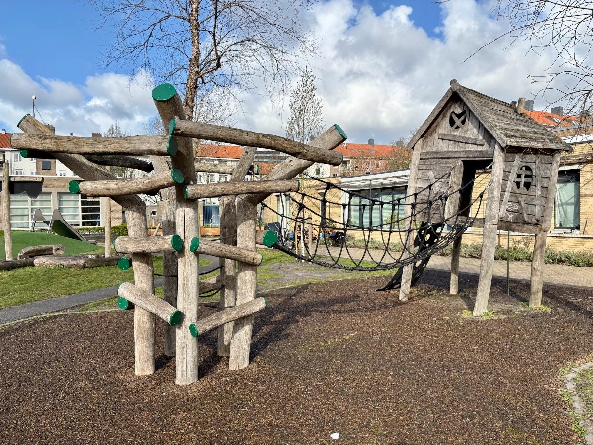 Wooden climbing structure and play house with rope bridge