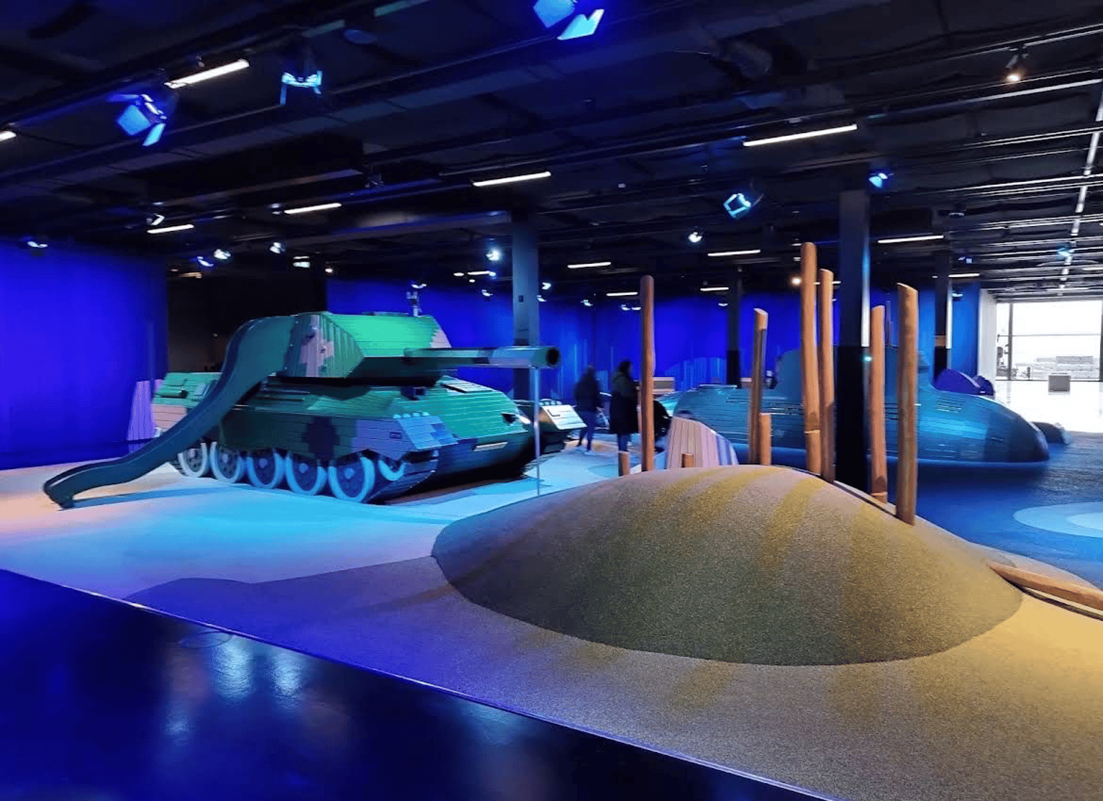 Military themed indoor playground with tank slide, climbing hill and play submarine