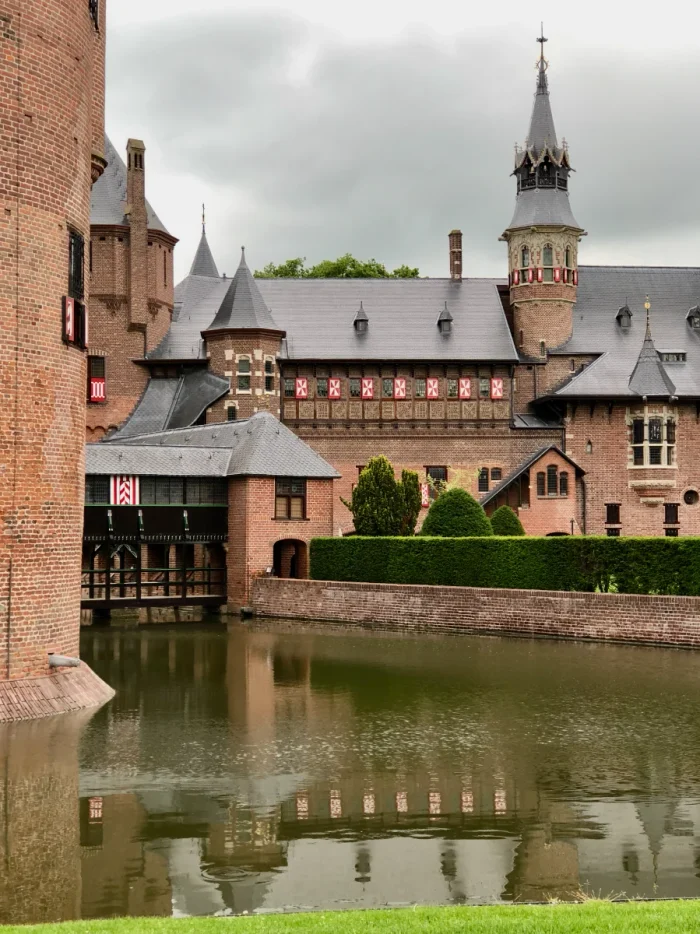 Brick castle with moat and reflection on the water