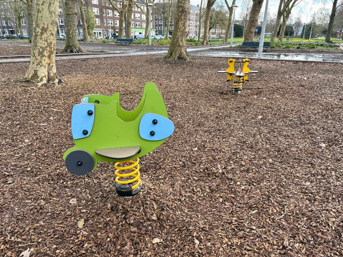 Bright green, blue, and yellow rockers at a playground