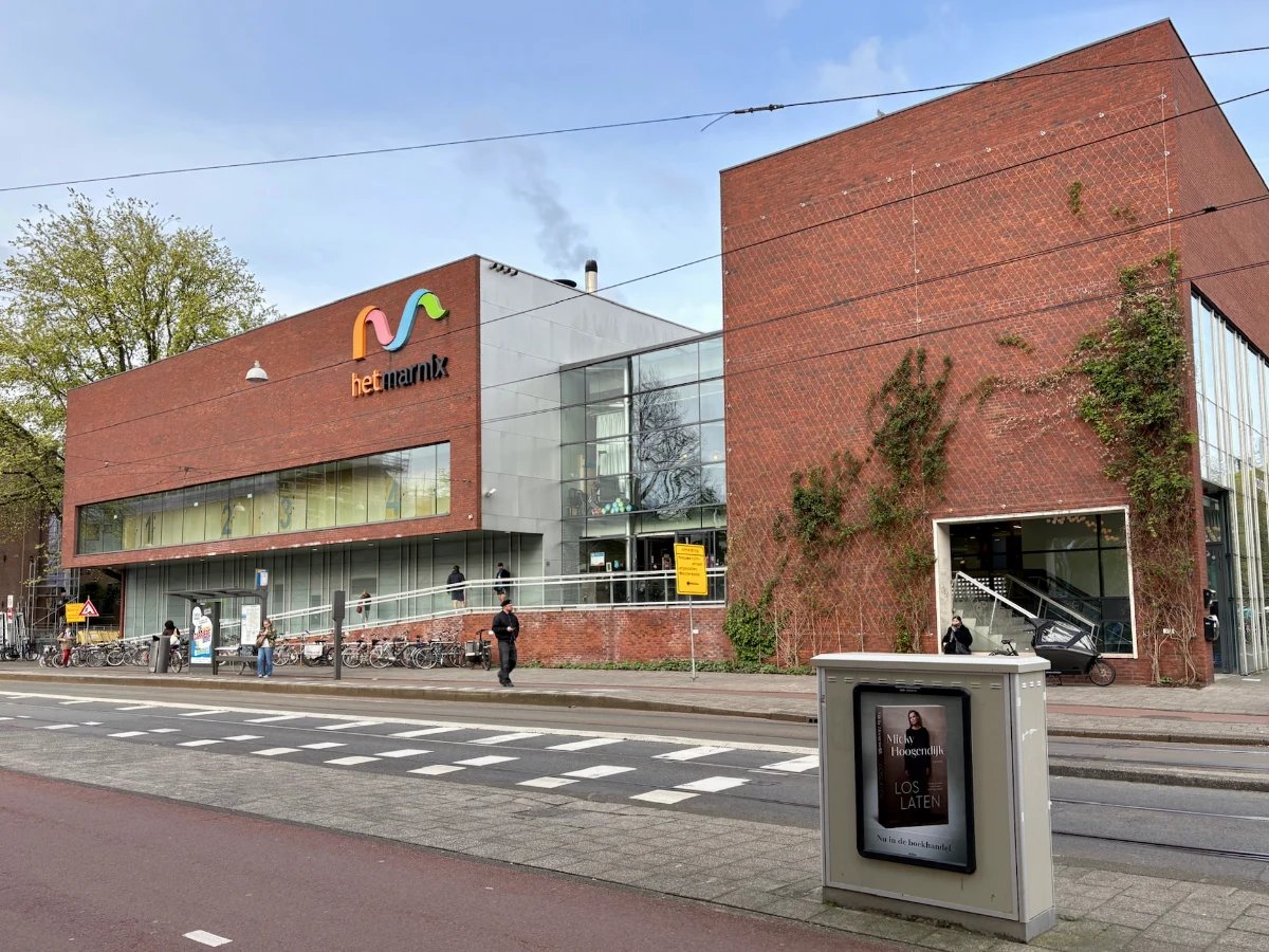 Modern brick building with glass entrance and large 