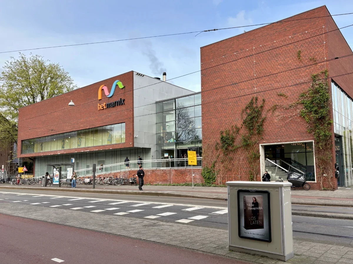 Modern brick building with glass entrance and large 