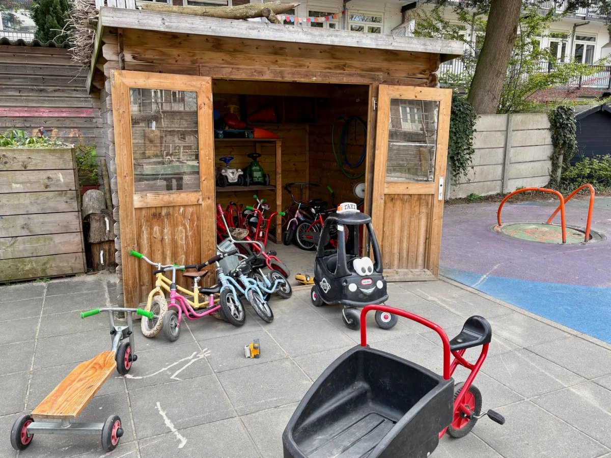 Wooden shed with children's bikes and vehicles