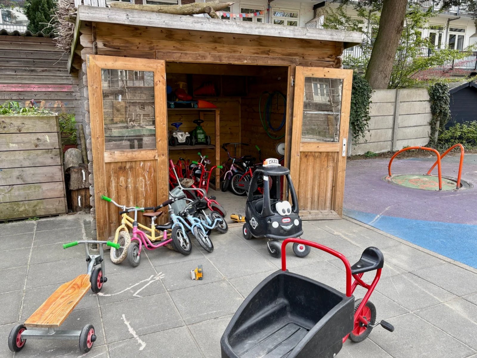 Wooden shed with children's bikes and vehicles