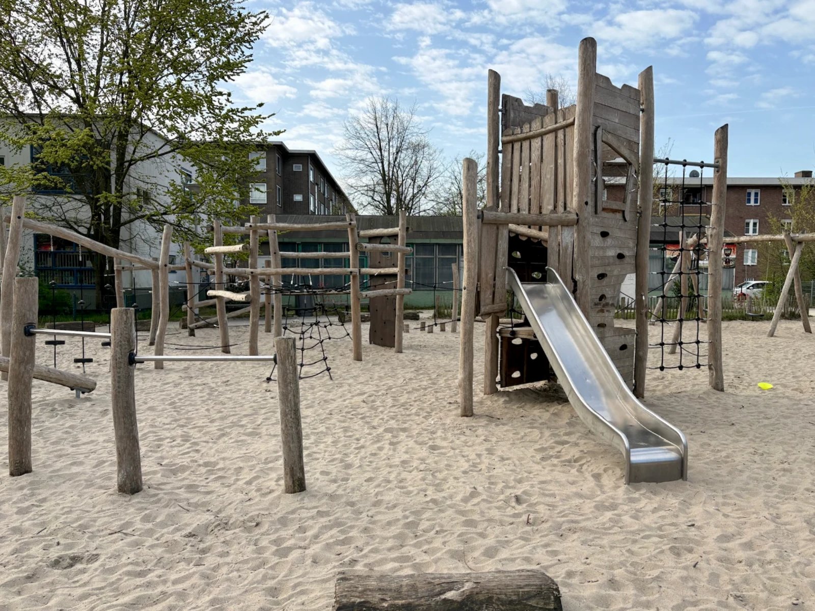 Wooden climbing obstacle course with ropes and slide