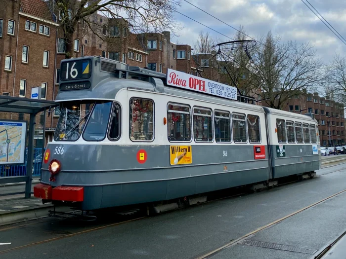 Grey, white and red vintage tram with period advertisements