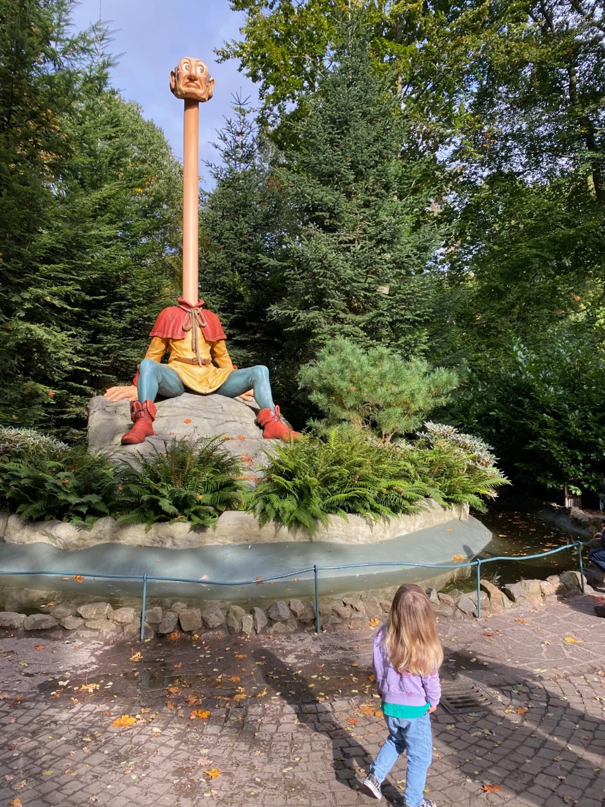 Whimsical outdoor animatronic man with very long neck