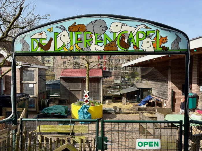 Colorful hand-painted sign with animals at the entrance to a children's farm