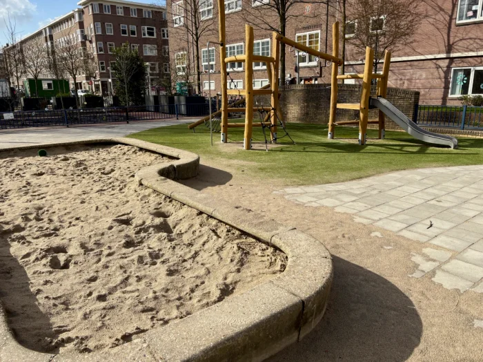 Sand box and small wooden climbing structure with slide for toddlers
