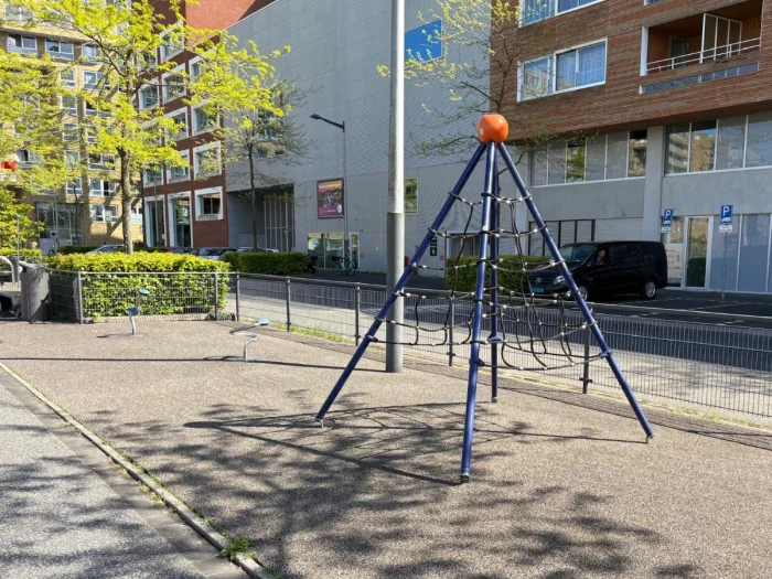 Climbing pyramid next to modern residential buildings