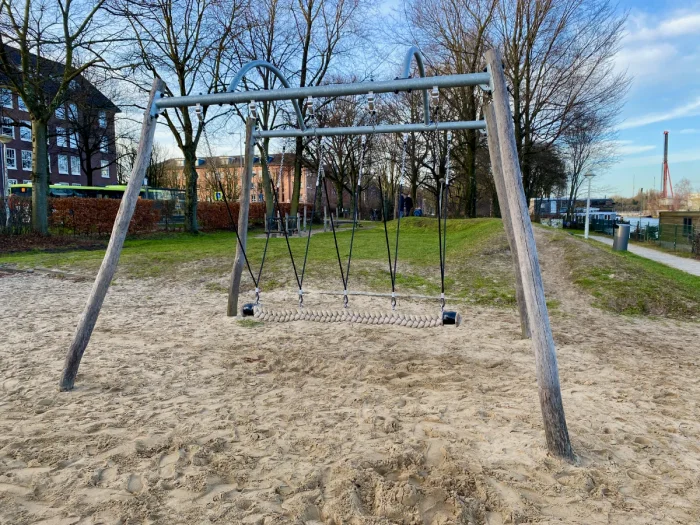 Wooden swing set with large rope as the seat