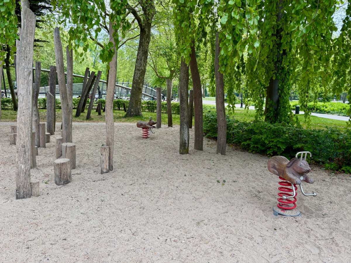 Shaded and sandy playground with natural wood 