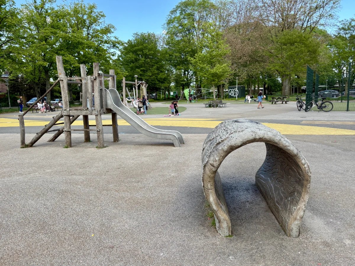 Small tunnel with wooden toddler slide behind