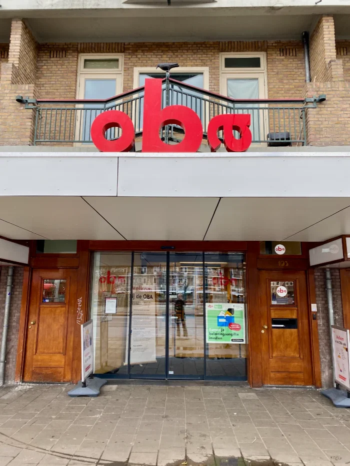 Entrance to OBA Mercatorplein public library with big red "OBA" letters above the doors