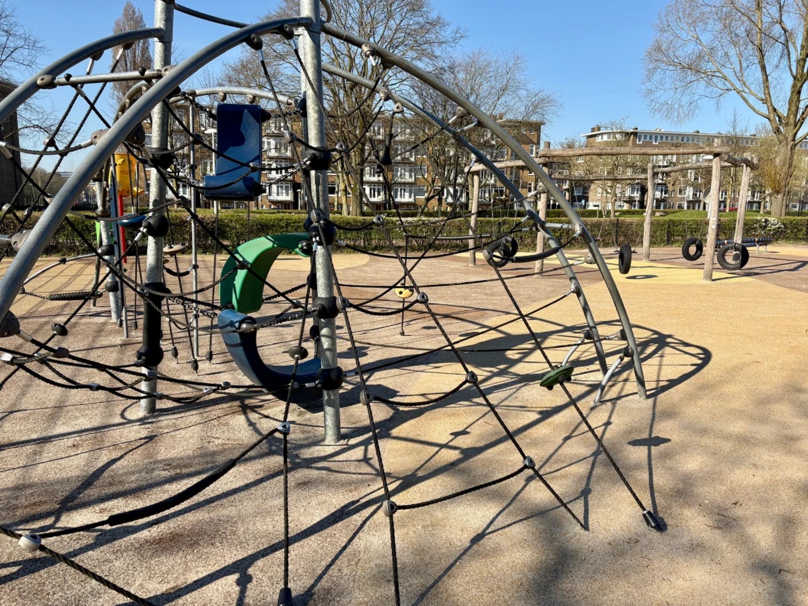 Large outdoor jungle gym with climbing ropes and hammocks