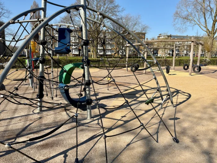 Large outdoor jungle gym with climbing ropes and hammocks