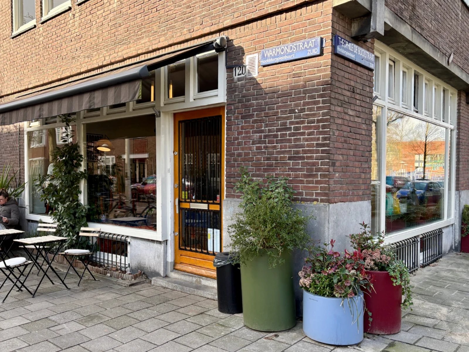 Entrance to coffee shop with a few tables outside
