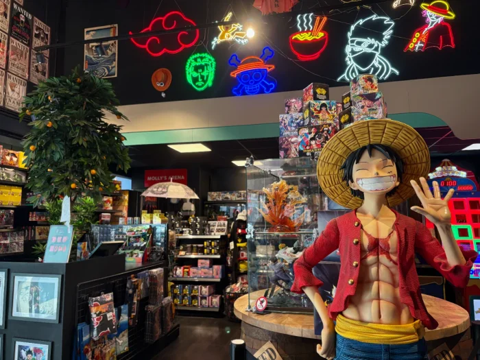 Anime shop with neon lights above and shelves full of memorabilia