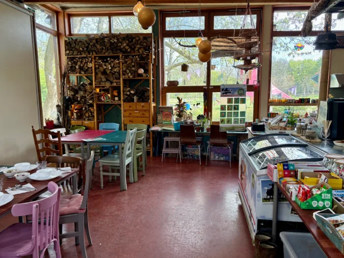 Community center cafe interior with eclectic furniture and decorations and counter with ice cream freezer