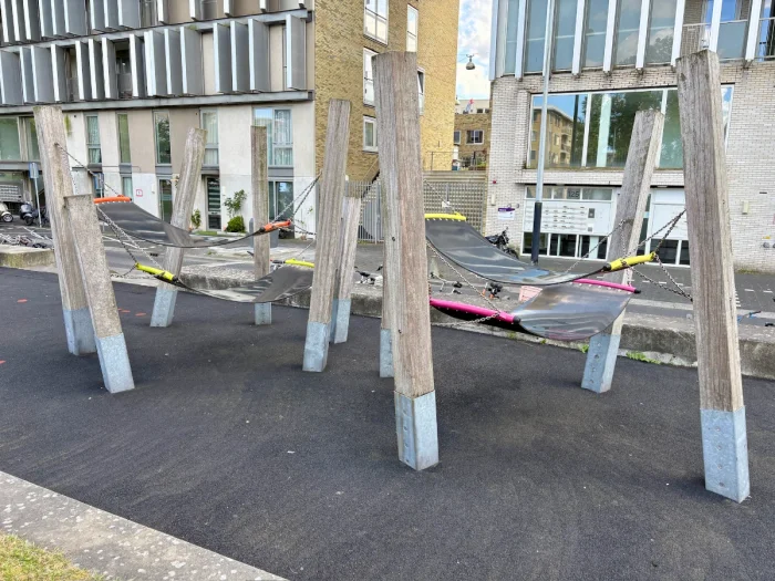 Rubber hammock forest with pink, yellow, orange accents and modern residential buildings behind