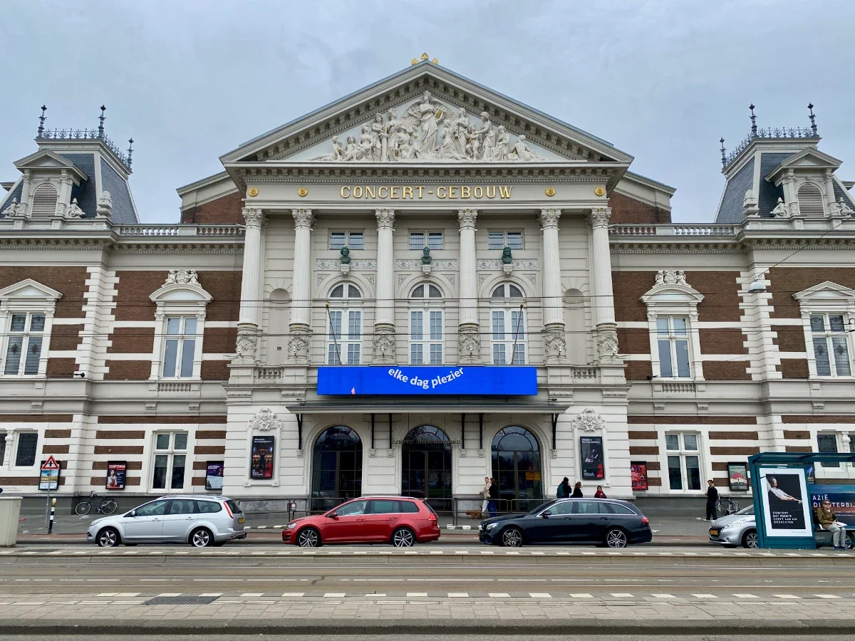 Front facade and entrance of historic concert hall in Neoclassical style with columns and ornate details
