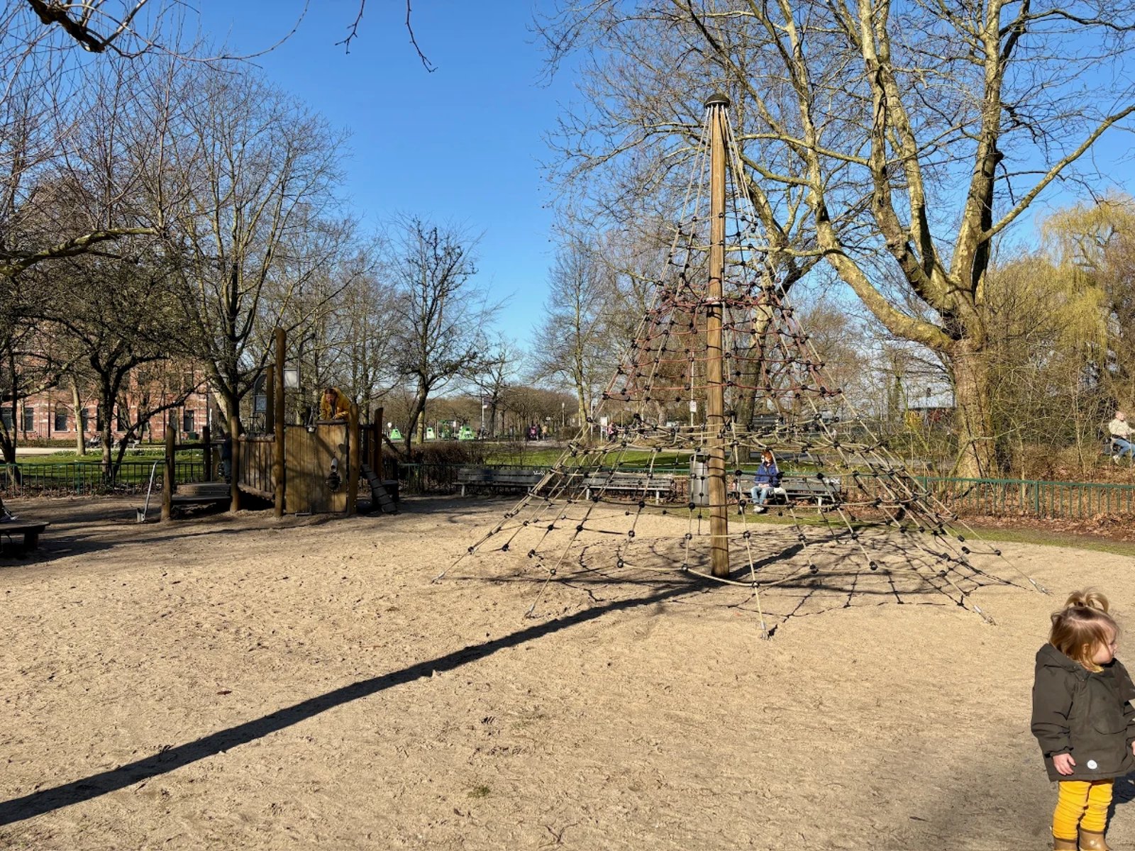 Playground with a tall, pyramid-shaped rope climbing tower