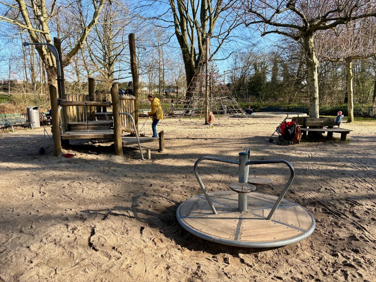 Playground with merry-go-round and wooden climbing structure