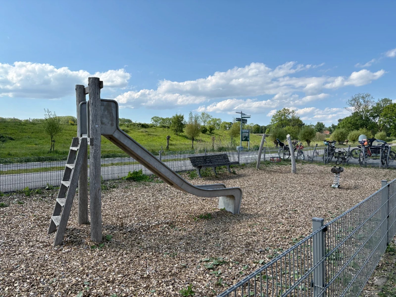 Small slide with ladder in sunny part setting